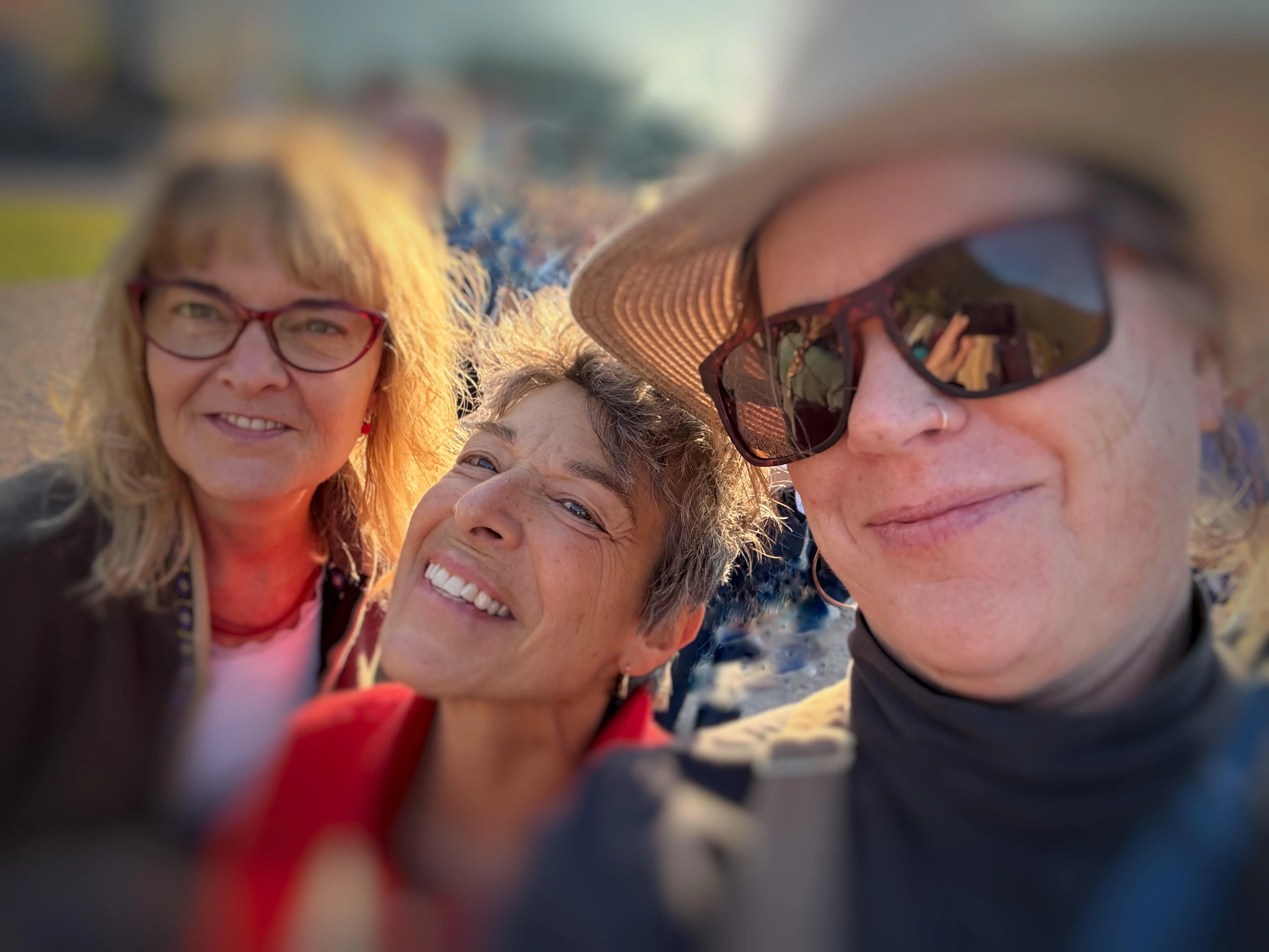 The three members of The Ready Bettys smiling together outdoors.