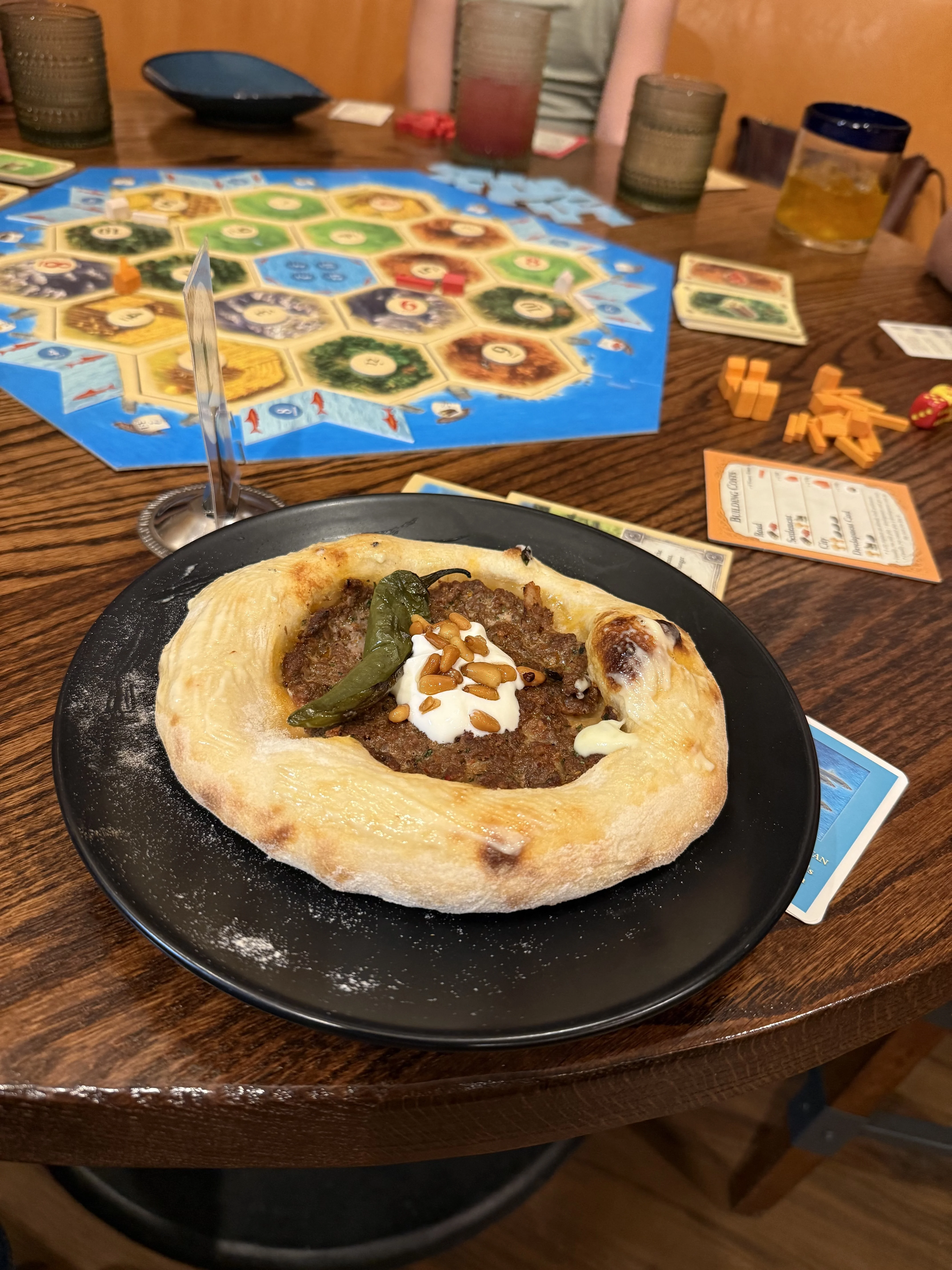 A board game and a plate of food on a table at Sumac Cafe.